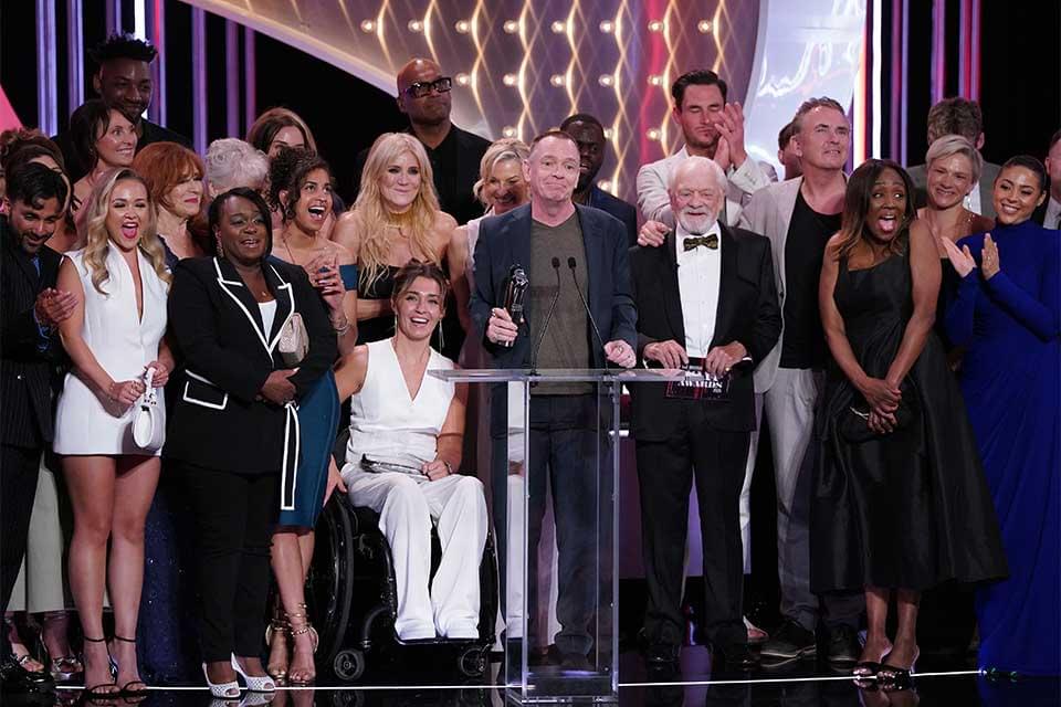 Cast and crew of EastEnders collect a British Soap Award
