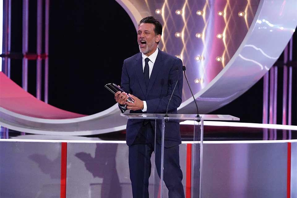Navin Chowdhry collecting a British Soap Awards trophy